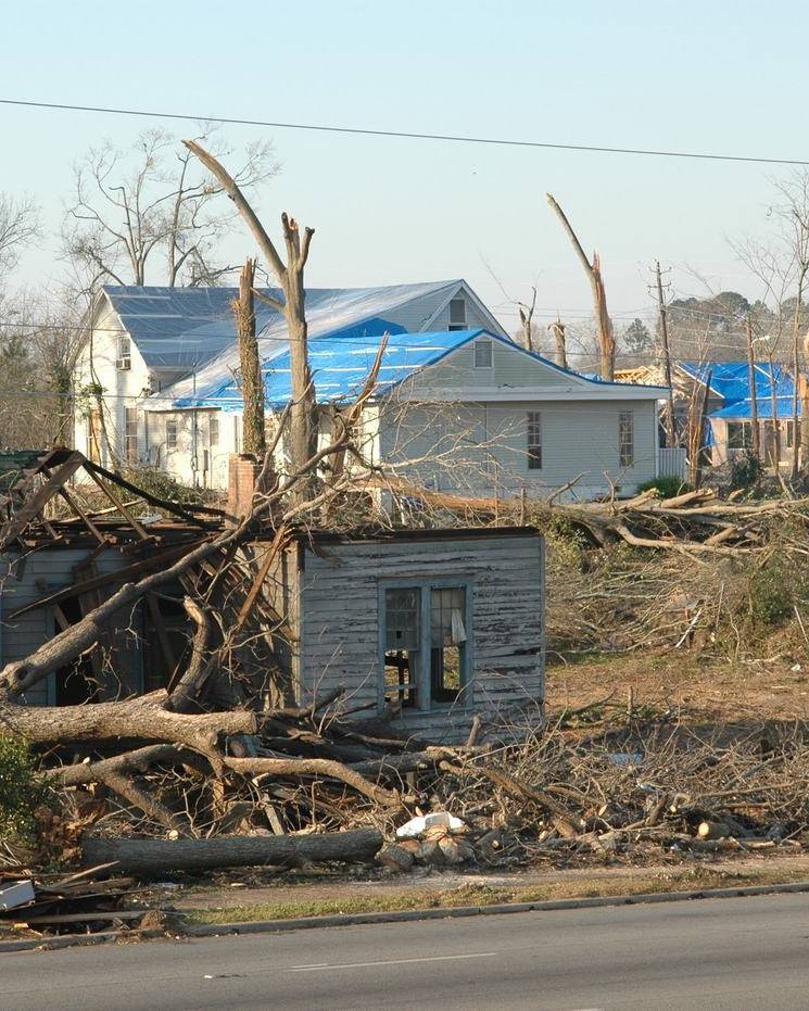 Blue tarps on storm-damaged roofs in Americus, Georgia